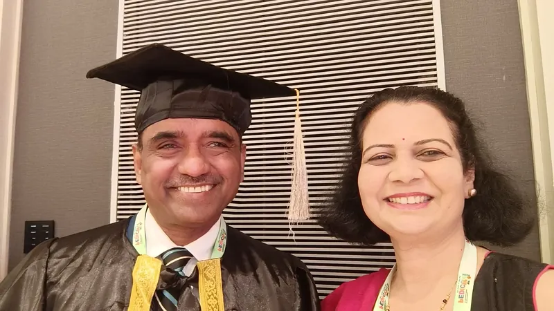 Dr. Ramakant Patil in academic regalia and cap, smiling beside Dr. Sadhana Patil.